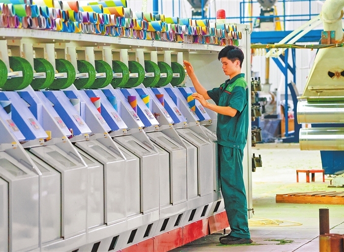 Workers busy at artificial grass factory in Qingfeng