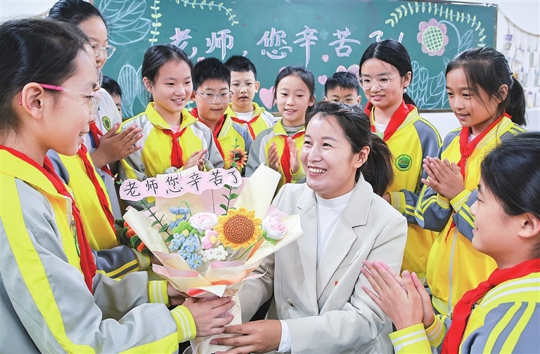 Students present handmade bouquets to teachers